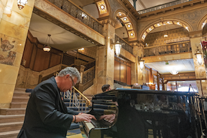 John Kite playing piano in the lobby of the Brown Palace. Photo by Joshua Hardin