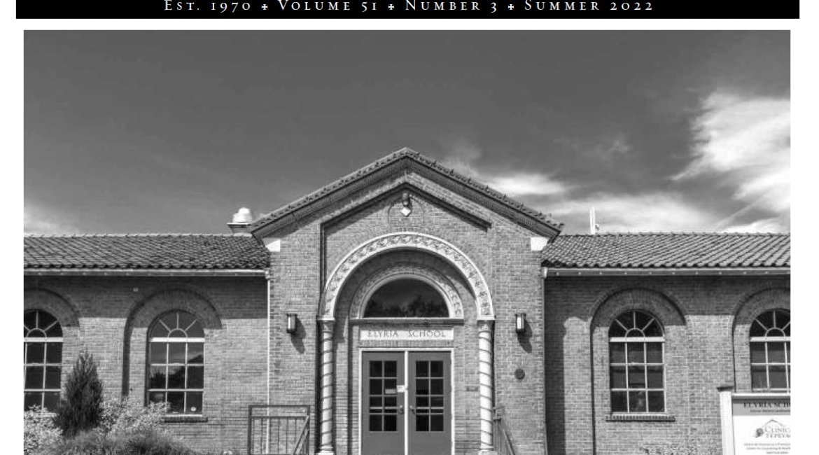 A screengrab of the cover image of the Historic Denver News newspaper. The paper features the name and then a large black and white image of the former Elyria School. A headline underneath reads "Exploring Preservation Action in Old Elyria"