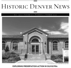 A screengrab of the cover image of the Historic Denver News newspaper. The paper features the name and then a large black and white image of the former Elyria School. A headline underneath reads "Exploring Preservation Action in Old Elyria"